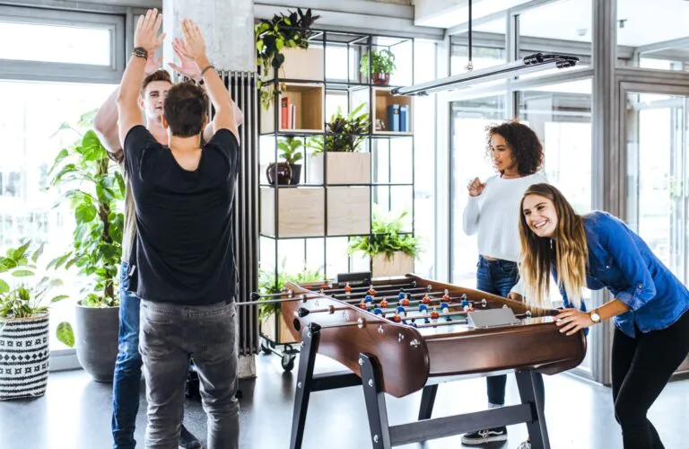 Students playing foosball in the Neon Wood Frankfurter Tor lobby — a student apartment with community spaces in Berlin